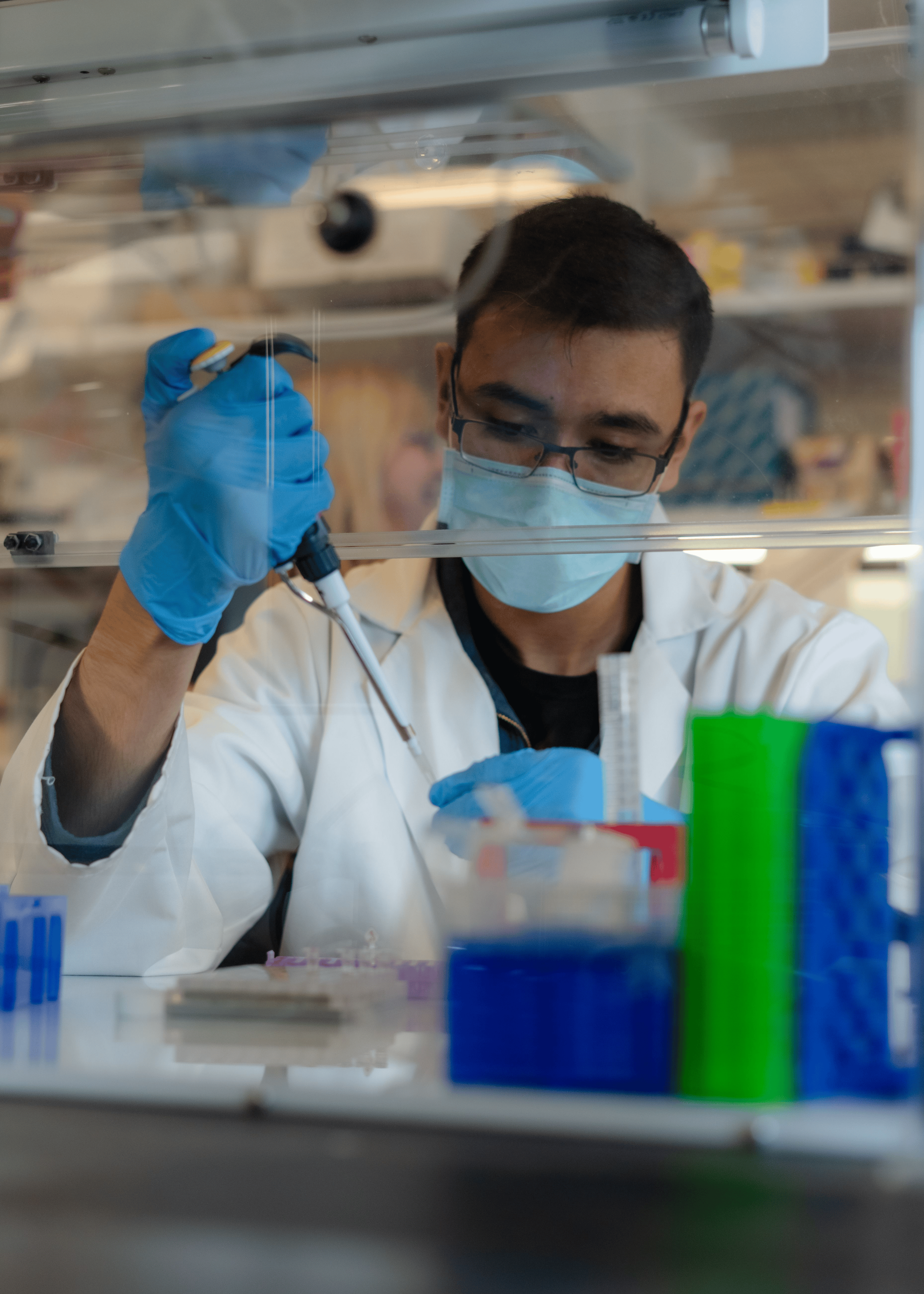 Male student in a mask works in a research lab