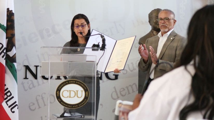CDU President Dr. David Carlisle stands with Congresswoman Nanette Barragán during the bill presentation.