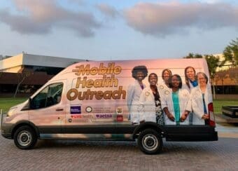 The Mobile Health Outreach Van parked in front of the CDU campus.