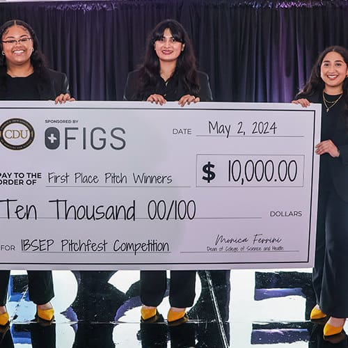 CDU Rising | Students Holding a check