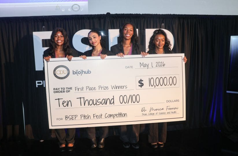 students holding large check
